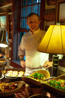 Chef Zack Comis, rotating between the ranch and the Broadmoor Hotel, puts the finishing touches on the buffet. The Ranch at Emerald Valley, Pike National Forest, Colorado Springs, CO. / EVR_IMG_2261 - ©Steve Haggerty/ColorWorld